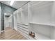 Spacious walk-in closet with custom shelving, drawers and a mirror offering stylish storage solutions at 14223 Lambert Bridge Ln, Lithia, FL 33547