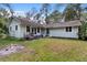 Charming home with a backyard, wooden deck, and lots of greenery at 15012 N 301 Hwy, Thonotosassa, FL 33592