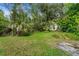 Wide backyard featuring lush lawn, and lots of green trees at 15012 N 301 Hwy, Thonotosassa, FL 33592