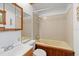 Bathroom featuring tub/shower combo, tile surround, and neutral color palette at 15012 N 301 Hwy, Thonotosassa, FL 33592