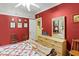 Comfortable bedroom with red walls, a ceiling fan and filled with natural light at 15012 N 301 Hwy, Thonotosassa, FL 33592