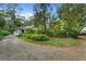 Charming single story home with lush landscaping and a long driveway at 15012 N 301 Hwy, Thonotosassa, FL 33592