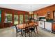 View of the traditional eat-in kitchen featuring wood cabinets and a sliding glass door to the backyard at 15012 N 301 Hwy, Thonotosassa, FL 33592