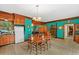 View of the traditional-style eat-in kitchen featuring wood cabinets and an adjacent sitting area at 15012 N 301 Hwy, Thonotosassa, FL 33592