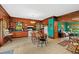 View of the traditional-style eat-in kitchen featuring wood cabinets and adjacent sitting area at 15012 N 301 Hwy, Thonotosassa, FL 33592