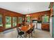 View of the traditional-style eat-in kitchen featuring wood cabinets and view to the backyard through sliding glass door at 15012 N 301 Hwy, Thonotosassa, FL 33592