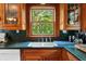 A close-up on the traditional-style kitchen sink and window overlooking backyard at 15012 N 301 Hwy, Thonotosassa, FL 33592