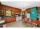 View of the traditional eat-in kitchen featuring wood cabinets and adjacent sitting area at 15012 N 301 Hwy, Thonotosassa, FL 33592