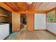 Bright laundry room with modern appliances and adjacent living space access at 15012 N 301 Hwy, Thonotosassa, FL 33592