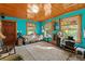 Elegant living room with hardwood ceilings and vibrant turquoise walls at 15012 N 301 Hwy, Thonotosassa, FL 33592