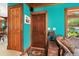 A vivid living room featuring wood trim, classic furniture, and an adjacent doorway at 15012 N 301 Hwy, Thonotosassa, FL 33592