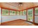 Sunroom with hardwood floors and white trim, offering abundant natural light at 15012 N 301 Hwy, Thonotosassa, FL 33592