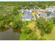 Beautiful overhead view of the property next to a pond with manicured lawn and neighborhood at 152 Glenn Moor Cir, Dunedin, FL 34698