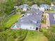 Aerial view of a townhouse complex with a private pool and manicured green lawns at 152 Glenn Moor Cir, Dunedin, FL 34698