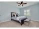 Comfortable bedroom with light blue walls, a queen-size bed, and a window with shutter-style blinds at 152 Glenn Moor Cir, Dunedin, FL 34698