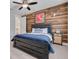 Stylish bedroom with a wood accent wall, ceiling fan, and modern furnishings at 152 Glenn Moor Cir, Dunedin, FL 34698