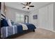 Serene bedroom with a ceiling fan, a bed with blue accents, and ample closet space at 152 Glenn Moor Cir, Dunedin, FL 34698