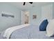 Serene bedroom with blue walls, a paisley comforter, and a view to the hallway through a partially opened door at 152 Glenn Moor Cir, Dunedin, FL 34698