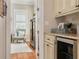 View of the butler's pantry with custom cabinetry, granite countertops, and convenient beverage refrigerator at 152 Glenn Moor Cir, Dunedin, FL 34698