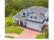 A beautiful exterior of the home, set on a landscaped lot with proximity to a tranquil pond at 152 Glenn Moor Cir, Dunedin, FL 34698