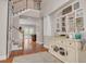 Expansive foyer includes staircase and decorator shelving and furniture along with hardwood flooring and neutral paint at 152 Glenn Moor Cir, Dunedin, FL 34698