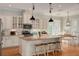 Bright kitchen with stainless steel appliances, granite counters, an island with seating and hardwood floors at 152 Glenn Moor Cir, Dunedin, FL 34698