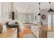 This kitchen shows the breakfast nook and stainless steel appliances with an island sink and stone countertops at 152 Glenn Moor Cir, Dunedin, FL 34698