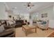 Large living room features an open concept design with lots of furniture and a view into the kitchen and backyard at 152 Glenn Moor Cir, Dunedin, FL 34698