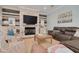 Cozy living room features a stone fireplace, hardwood floors and comfortable seating at 152 Glenn Moor Cir, Dunedin, FL 34698