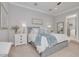 Beautifully staged main bedroom features neutral tones, stylish decor, and plenty of natural light at 152 Glenn Moor Cir, Dunedin, FL 34698