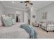 Well-appointed main bedroom featuring plantation shutters and comfortable seating area at 152 Glenn Moor Cir, Dunedin, FL 34698