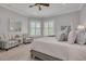 Relaxing main bedroom showcasing large windows, plantation shutters, and comfortable sitting area at 152 Glenn Moor Cir, Dunedin, FL 34698