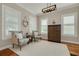 Spacious office featuring hardwood floors, plantation shutters, custom lighting, and comfortable seating at 152 Glenn Moor Cir, Dunedin, FL 34698