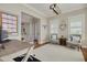 Bright home office featuring hardwood floors, plantation shutters, stylish furnishings, and ample workspace at 152 Glenn Moor Cir, Dunedin, FL 34698
