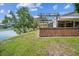 Backyard deck with pergola overlooking a serene lake, perfect for outdoor relaxation and entertainment at 15202 Morning Dr, Lutz, FL 33559