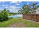 Backyard deck with pergola overlooking a serene lake at 15202 Morning Dr, Lutz, FL 33559