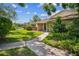 Charming single-Gathering home featuring a waterside deck, a well-maintained lawn, and inviting curb appeal at 15202 Morning Dr, Lutz, FL 33559