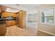 Bright kitchen with stainless steel refrigerator, wood cabinets, and seamless flow into the dining area at 15202 Morning Dr, Lutz, FL 33559