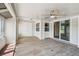 Enclosed sunroom with lots of natural light and wood-look floors, creating a comfortable and flexible living space at 15202 Morning Dr, Lutz, FL 33559