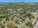 Wide aerial view of neighborhood with tree coverage and glimpse of the ocean in the distance at 1530 21St N Ave, St Petersburg, FL 33704