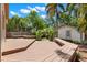 A backyard deck with built in benches and stairs to the green yard and shed at 1530 21St N Ave, St Petersburg, FL 33704