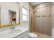 Updated bathroom featuring tiled shower, modern vanity with white sink and large framed mirror at 1530 21St N Ave, St Petersburg, FL 33704