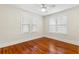 Bright bedroom with polished hardwood floors, ceiling fan, and natural light from two windows at 1530 21St N Ave, St Petersburg, FL 33704