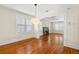 Bright dining room showing hardwood floors, elegant light fixture, and open flow to the living room at 1530 21St N Ave, St Petersburg, FL 33704