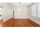 Elegant dining room featuring gleaming hardwood floors, a stylish pendant light, and ample natural light at 1530 21St N Ave, St Petersburg, FL 33704