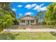 Inviting single-story home featuring a well-maintained front yard with lush landscaping and a sidewalk at 1530 21St N Ave, St Petersburg, FL 33704