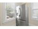 A stainless steel refrigerator is featured in the kitchen with a view to the outdoors at 1530 21St N Ave, St Petersburg, FL 33704