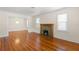 Bright living room with a decorative fireplace, gleaming hardwood floors, and a cozy ambiance at 1530 21St N Ave, St Petersburg, FL 33704