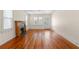 Inviting living room with gleaming hardwood floors, a decorative fireplace, and a charming front door at 1530 21St N Ave, St Petersburg, FL 33704
