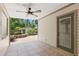 An outdoor patio with a ceiling fan, door and windows, and a view of the backyard at 1530 21St N Ave, St Petersburg, FL 33704